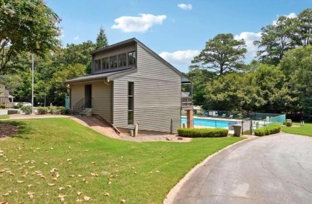 view of side of home with a yard