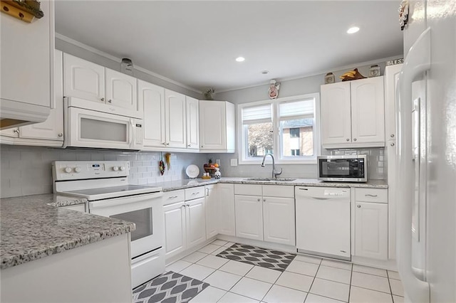 kitchen featuring sink, white appliances, backsplash, light stone counters, and white cabinets