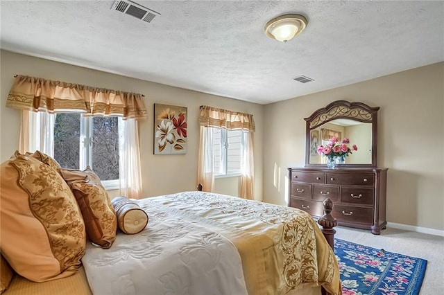 carpeted bedroom with a textured ceiling