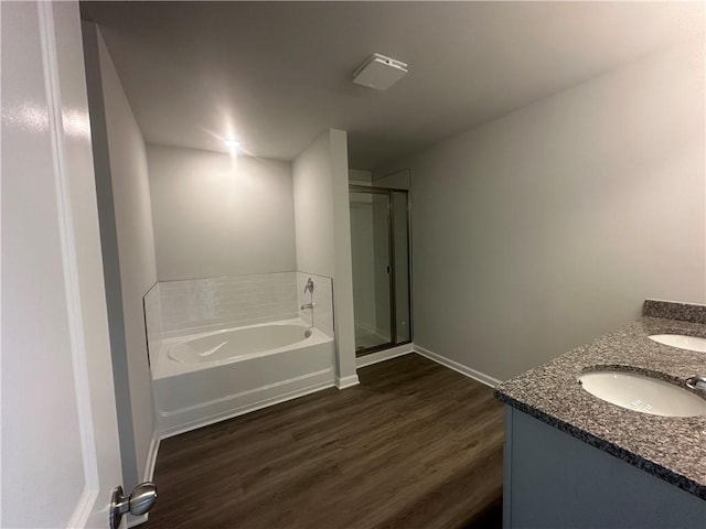 133 Observation Way, Dallas, GA 30132 - bathroom featuring a garden tub, wood finished floors, baseboards, and double vanity