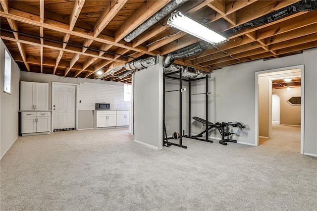 basement with light colored carpet and baseboards