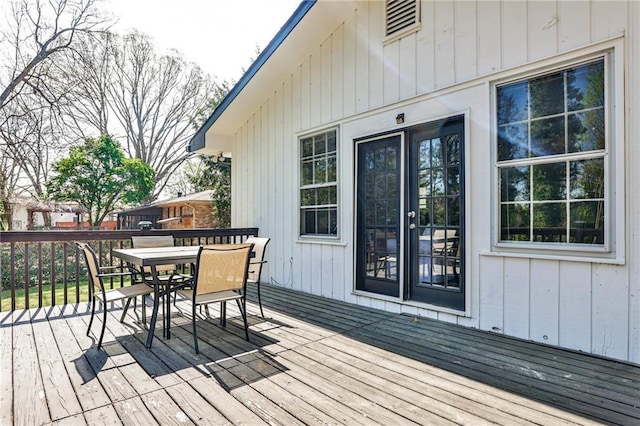 wooden terrace with outdoor dining area