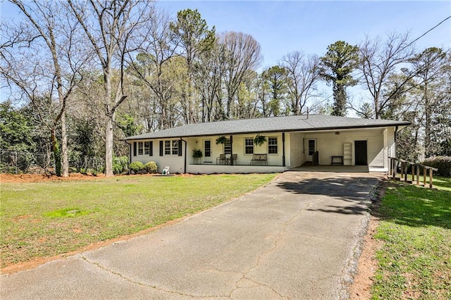 single story home with a porch, fence, aphalt driveway, a carport, and a front yard