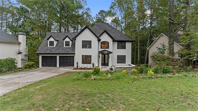 view of front of house with a garage and a front yard