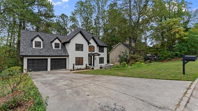 view of front of property with a garage and a front lawn