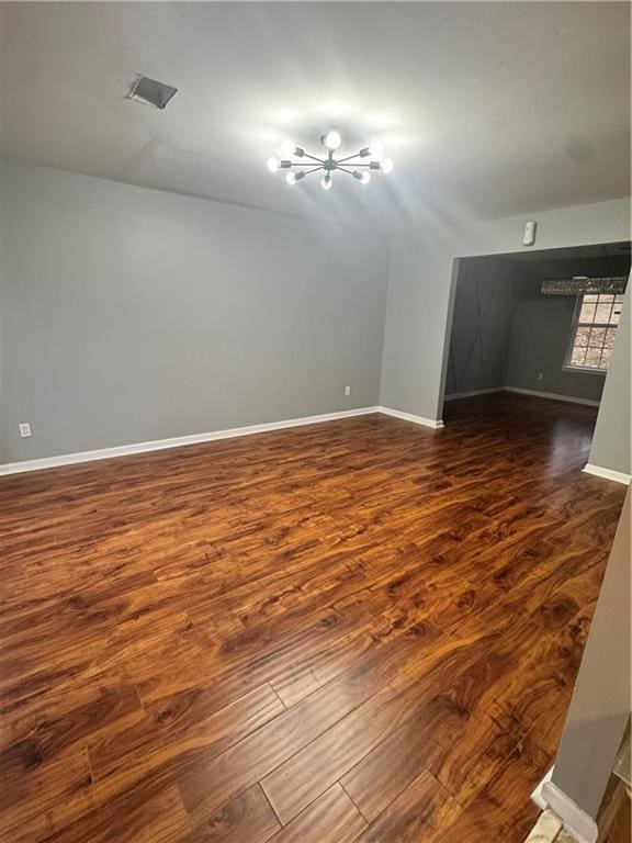 unfurnished room featuring dark wood-type flooring