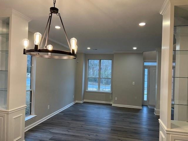 unfurnished dining area featuring dark wood finished floors, crown molding, and recessed lighting