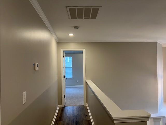 stairs featuring crown molding, a decorative wall, a high ceiling, and wood finished floors