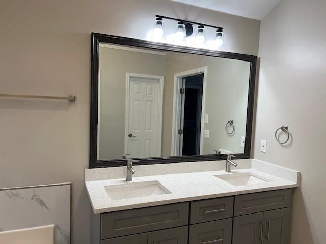 full bathroom with double vanity and a sink