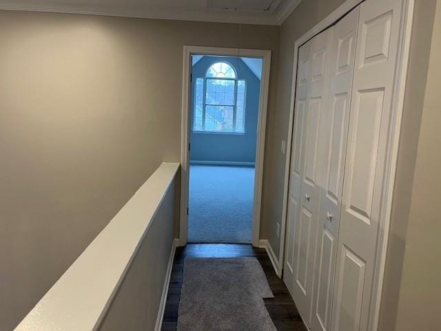 corridor with attic access, dark wood finished floors, and crown molding