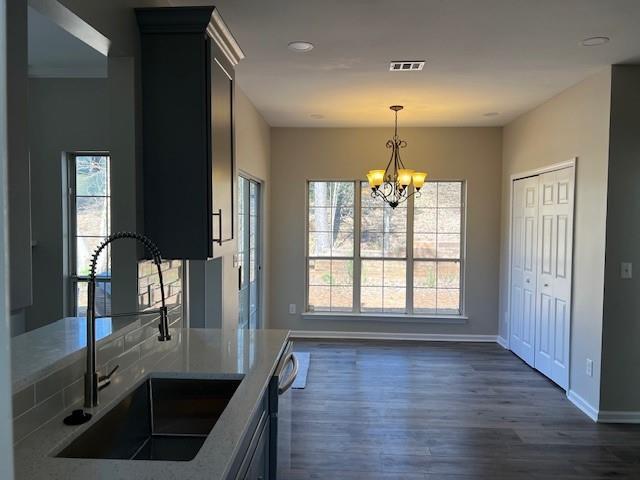 kitchen with dark wood finished floors, light countertops, visible vents, gray cabinetry, and appliances with stainless steel finishes