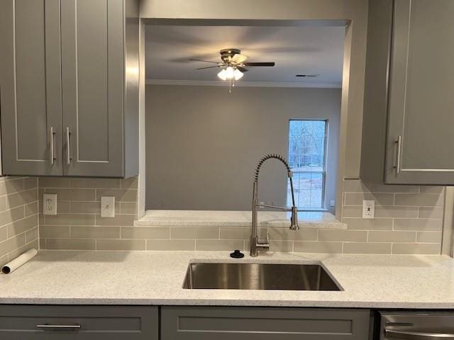 kitchen with crown molding, a sink, and gray cabinetry