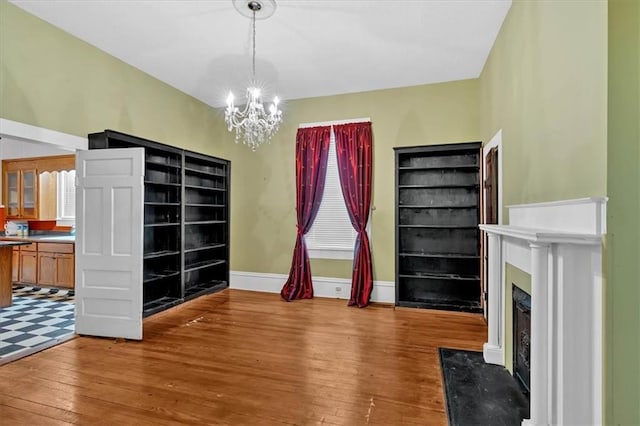 226 Noyes St, Cedartown, GA 30125 - unfurnished living room with a chandelier, hardwood / wood-style floors, and a fireplace