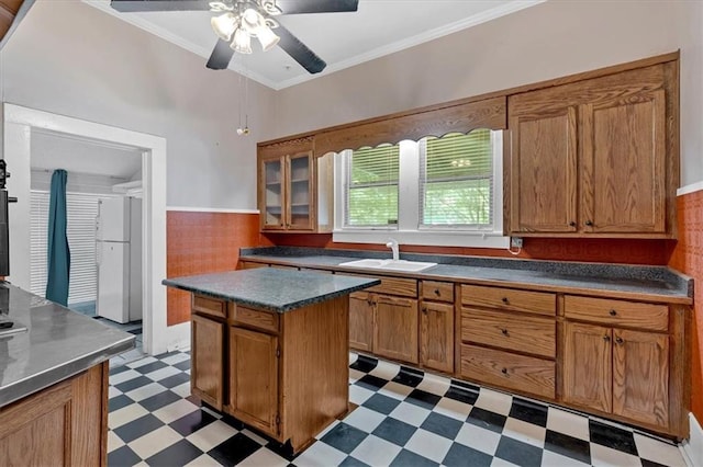 226 Noyes St, Cedartown, GA 30125 - kitchen with freestanding refrigerator, light flooring, ceiling fan, brown cabinets, and dark countertops