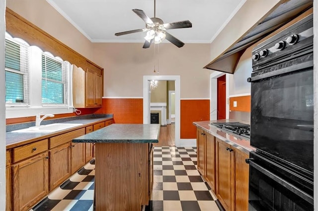 226 Noyes St, Cedartown, GA 30125 - kitchen with oven, light floors, stainless steel gas cooktop, wainscoting, and ceiling fan