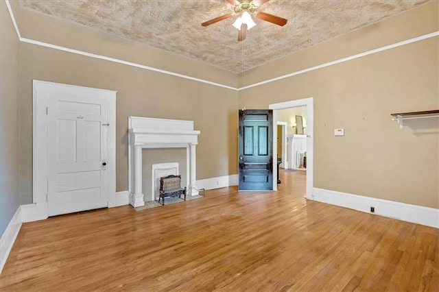 226 Noyes St, Cedartown, GA 30125 - unfurnished living room featuring ceiling fan, light wood-style flooring, and a fireplace with flush hearth
