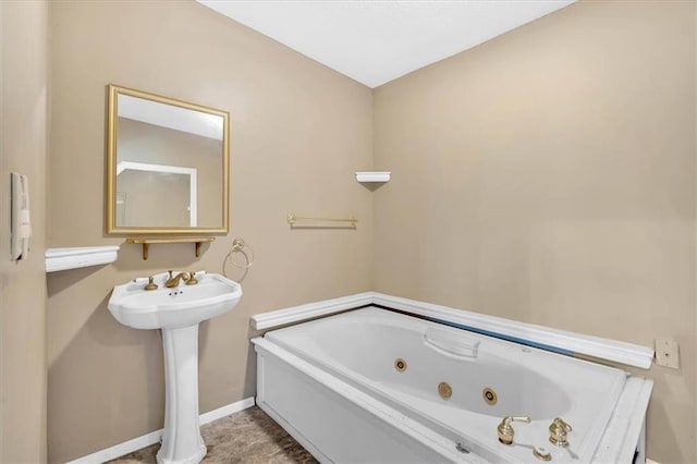 226 Noyes St, Cedartown, GA 30125 - bathroom featuring a tub with jets and baseboards