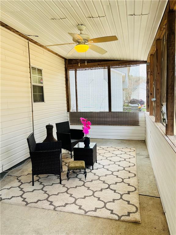 sunroom featuring wooden ceiling and ceiling fan