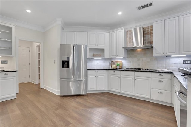 2255 Lenox Ridge Ct NE, Atlanta, GA 30319 - kitchen with stainless steel appliances, wall chimney range hood, white cabinets, light wood-style floors, and ornamental molding