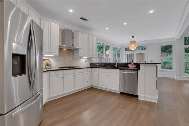 2255 Lenox Ridge Ct NE, Atlanta, GA 30319 - kitchen with stainless steel appliances, wall chimney range hood, plenty of natural light, wood finished floors, and recessed lighting