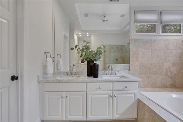 2255 Lenox Ridge Ct NE, Atlanta, GA 30319 - bathroom featuring double vanity, a bath, tiled shower, a ceiling fan, and a raised ceiling