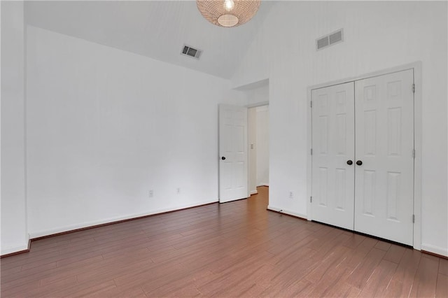 2255 Lenox Ridge Ct NE, Atlanta, GA 30319 - unfurnished bedroom featuring high vaulted ceiling, wood finished floors, and a closet
