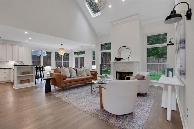 2255 Lenox Ridge Ct NE, Atlanta, GA 30319 - living area with light wood-type flooring, a fireplace, high vaulted ceiling, recessed lighting, and a skylight