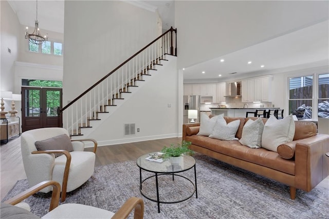 2255 Lenox Ridge Ct NE, Atlanta, GA 30319 - living room featuring a towering ceiling, a chandelier, wood finished floors, stairway, and recessed lighting