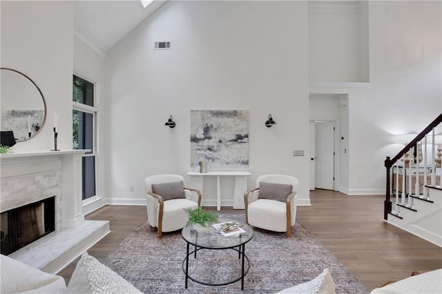 2255 Lenox Ridge Ct NE, Atlanta, GA 30319 - living area featuring high vaulted ceiling, stairs, wood finished floors, baseboards, and a tile fireplace