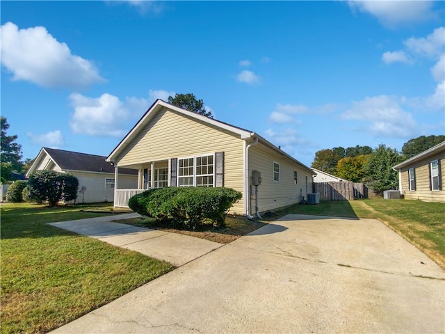 view of front of home with a front lawn and central air condition unit