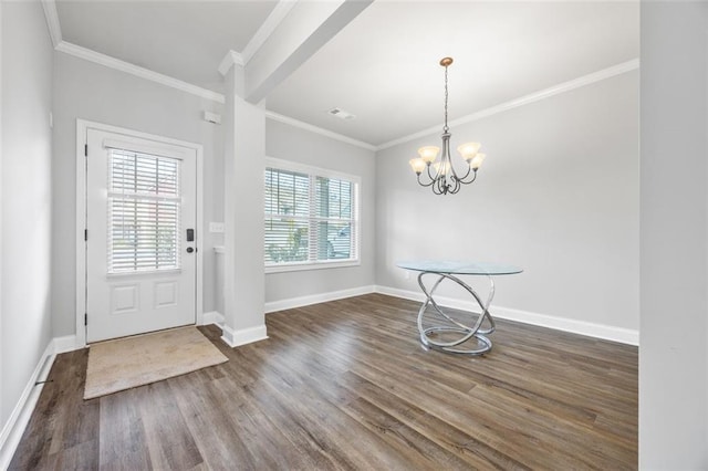 foyer featuring ornamental molding, dark wood-type flooring, and an inviting chandelier