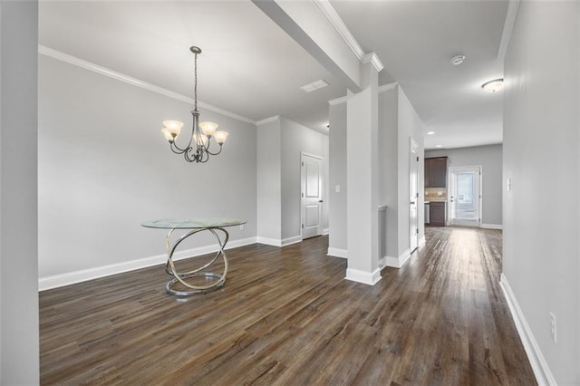 unfurnished dining area featuring crown molding, dark hardwood / wood-style floors, and a notable chandelier