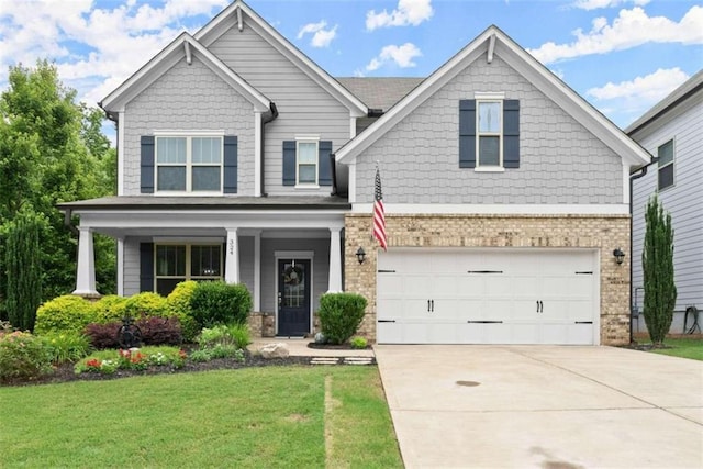 craftsman inspired home featuring a garage and a front lawn