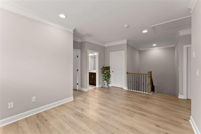 spare room with light wood-type flooring and crown molding