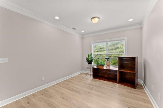 sitting room with ornamental molding and light hardwood / wood-style flooring