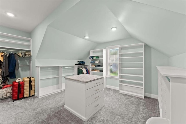 spacious closet with light carpet and lofted ceiling