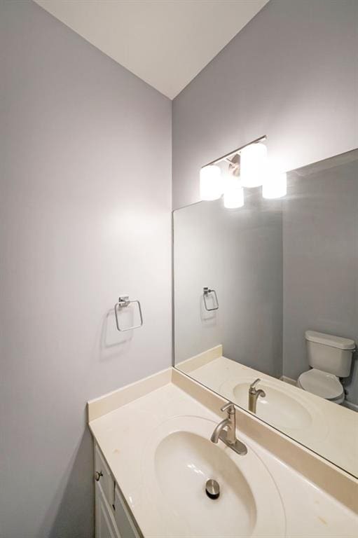 bathroom featuring vanity and toilet