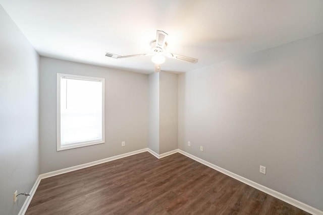 unfurnished room with ceiling fan and dark wood-type flooring