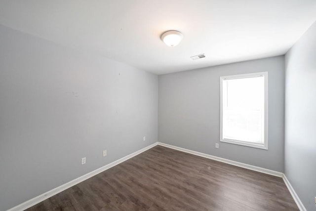 unfurnished room featuring dark hardwood / wood-style flooring