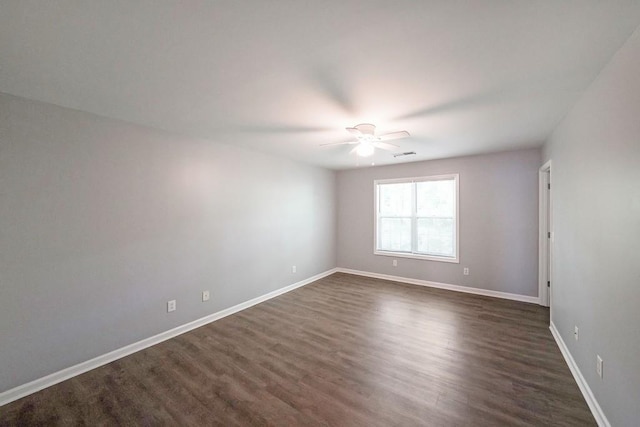 spare room featuring dark hardwood / wood-style floors and ceiling fan