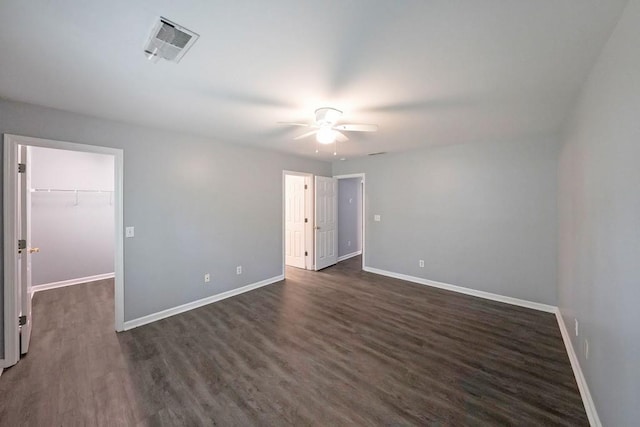 unfurnished room with ceiling fan and dark wood-type flooring