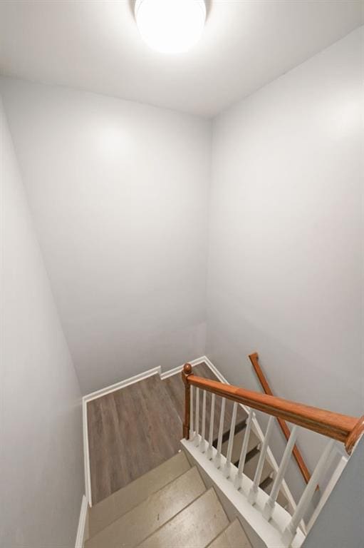 stairs with hardwood / wood-style floors