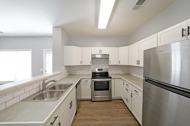 kitchen with stainless steel appliances, sink, and white cabinetry