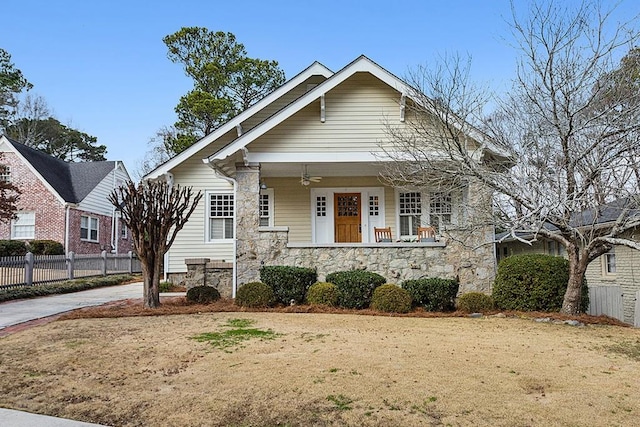 bungalow featuring a porch and a front lawn