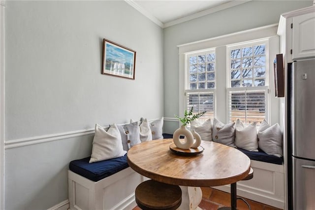 dining room featuring breakfast area and ornamental molding