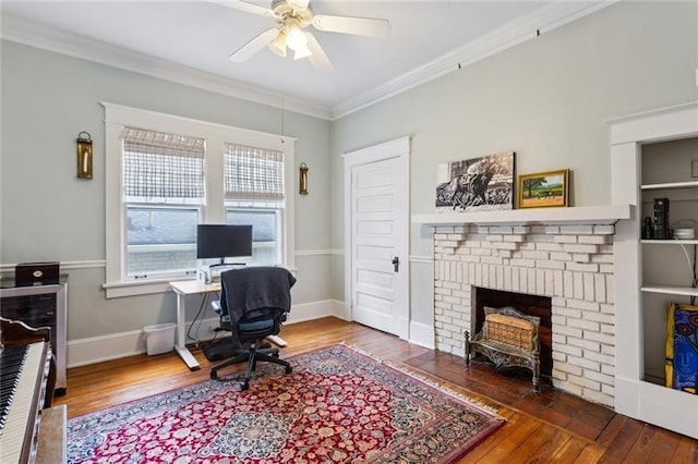 office featuring crown molding, dark hardwood / wood-style floors, ceiling fan, and a fireplace