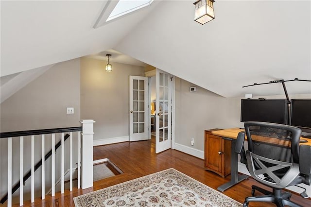 office area with french doors, lofted ceiling with skylight, and dark wood-type flooring