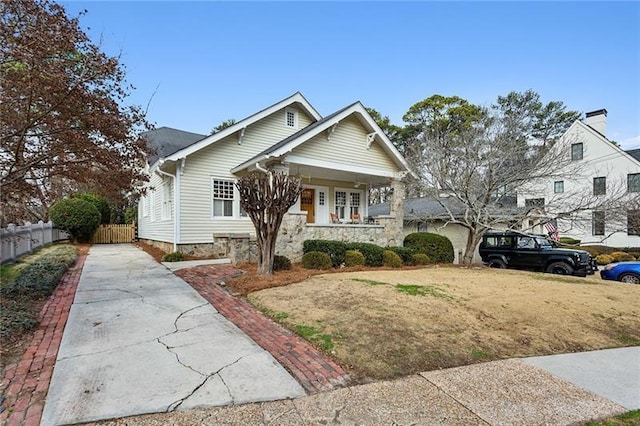 bungalow-style home with a front yard and a porch