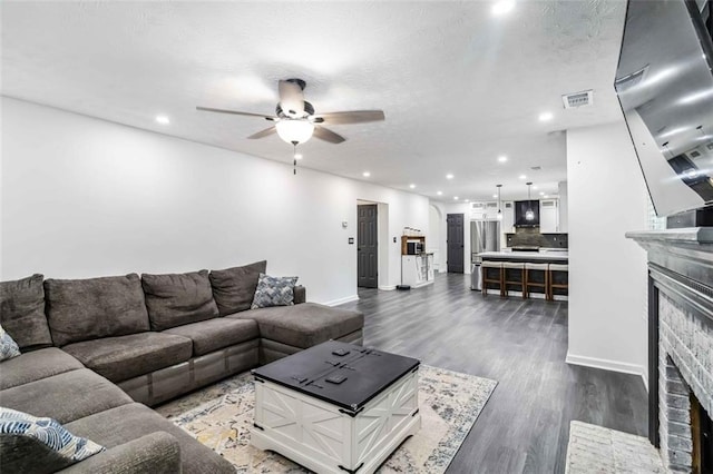 870 Underhill Ct, Sugar Hill, GA 30518 - living area with a fireplace, a ceiling fan, dark wood-type flooring, baseboards, and recessed lighting