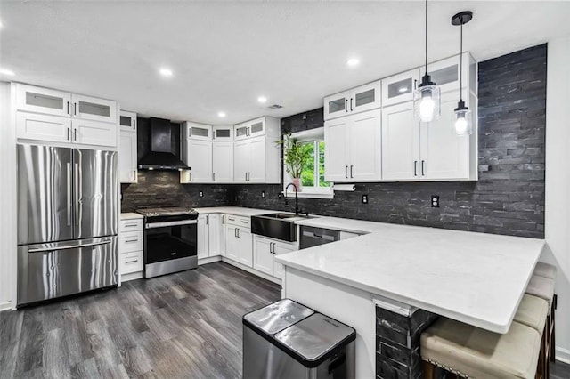 870 Underhill Ct, Sugar Hill, GA 30518 - kitchen featuring stainless steel appliances, wall chimney range hood, a sink, a peninsula, and decorative backsplash
